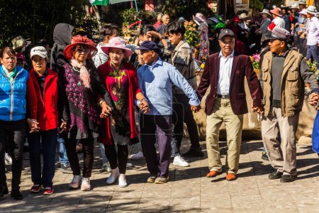 Photo for LIJIANG, CHINA  - NOVEMBER 8, 2019: Local people dance in the old town of Lijiang, Yunnan province, China - Royalty Free Image