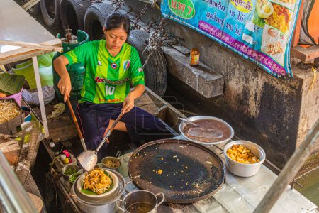 Photo for BANGKOK, THAILAND - DECEMBER 14, 2019: Cooking at Taling Chan floating market in Bangkok, Thailand - Royalty Free Image