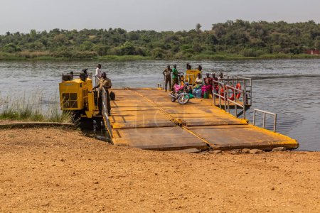 Photo for MURCHISON FALLS, UGANDA - MARCH 8, 2020: Ferry across Victoria Nile in Murchison Falls national park, Uganda - Royalty Free Image