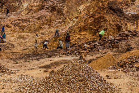 Photo for KABALE, UGANDA - MARCH 18, 2020: Local people excavating stone in a quarry near Kabale, Uganda - Royalty Free Image
