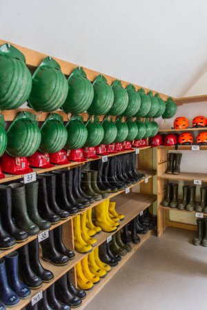 Photo for OBERWOLFACH, GERMANY - SEPTEMBER 2, 2019:  Storage of helmets nad rubber boots for tourists in Wenzel Pit (Grube Wenzel) former silver mine in Oberwolfach town in Baden-Wuerttemberg, Germany - Royalty Free Image