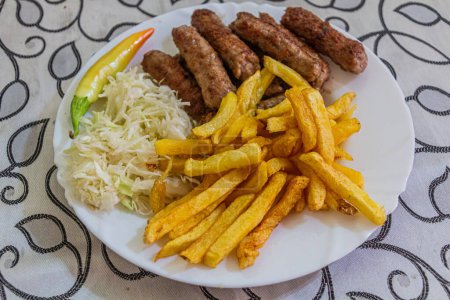 Photo for Meal in North Macedonia - cevapi with fries. - Royalty Free Image
