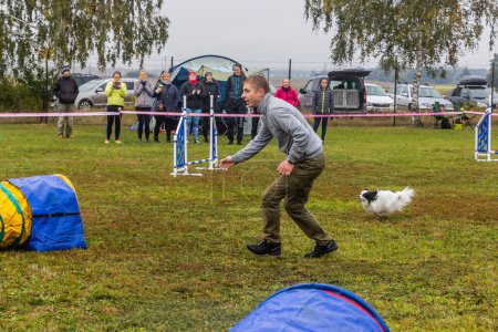 Photo for LYSA NAD LABEM, CZECH REPUBLIC - SEPTEMBER 28, 2020: Dog and a handler during agility competition in Lysa nad Labem, Czech Republic - Royalty Free Image