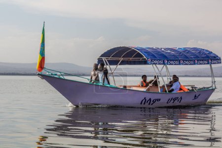 Photo for HAWASSA, ETHIOPIA - JANUARY 26, 2020: Tourists at a small boat on Awassa lake, Ethiopia - Royalty Free Image