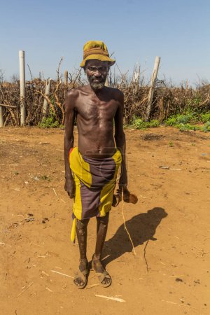 Photo for OMORATE, ETHIOPIA - FEBRUARY 5, 2020: Member of Daasanach tribe in his village near Omorate, Ethiopia - Royalty Free Image