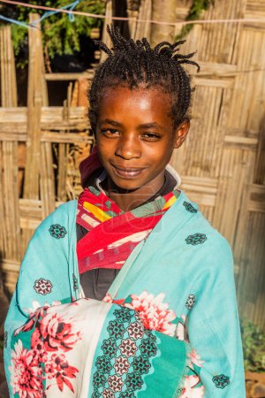 Photo for DORZE, ETHIOPIA - JANUARY 29, 2020: Girl of Dorze ethnicity in her village, Ethiopia - Royalty Free Image