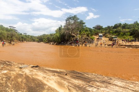 Photo for OMO VALLEY, ETHIOPIA - FEBRUARY 4, 2020: People waiting at the ford of Kizo river, Ethiopia - Royalty Free Image