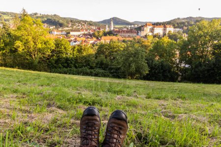Photo for Hiker's boots and Cesky Krumlov town and castle, Czech Republic - Royalty Free Image
