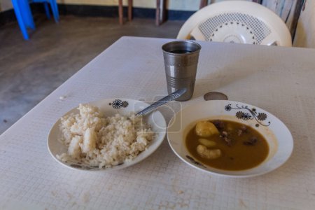 Photo for Rice with soup, simple meal in an eatery in South Horr village, Kenya - Royalty Free Image