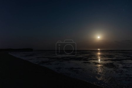 Luna brillando sobre una costa de la isla de Farasán, Arabia Saudita
