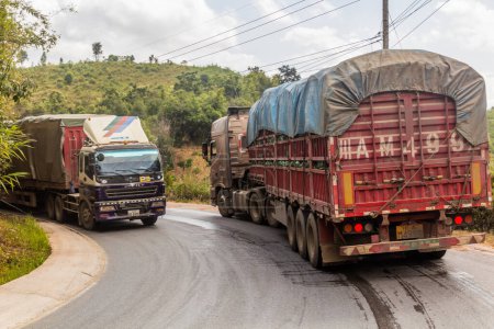 Photo for LUANG NAMTHA, LAOS - NOVEMBER 20, 2019: Trucks on a road near Luang Namtha town, Laos - Royalty Free Image