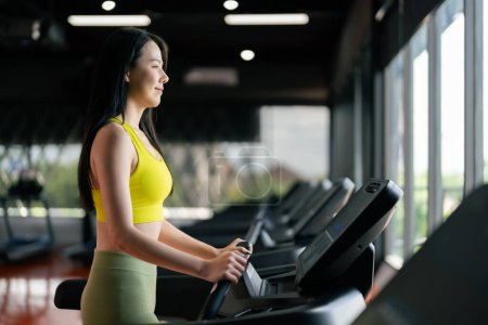 Photo for Young Asian Woman Running on Treadmill - Fitness Gym Exercise - Royalty Free Image