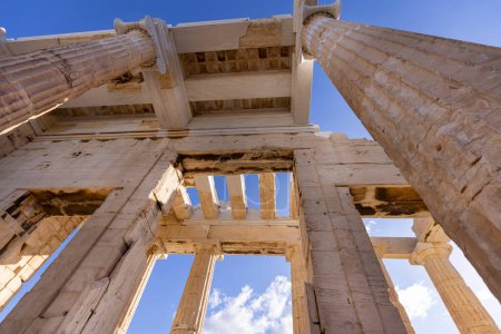 Photo for Propylaia, monumental ceremonial gateway with great columns to the Acropolis of Athens, Greece. It is an ancient citadel located on a rocky slope above the city - Royalty Free Image