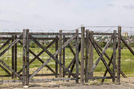 Photo for Majdanek; Lublin; Poland - May 25, 2022: Majdanek concentration and extermination camp, view on barbed wire fence. It was a Nazi camp built and operated by the SS during the German occupation of Poland in World War II - Royalty Free Image