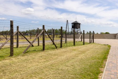 Photo for Majdanek; Lublin; Poland - May 25, 2022: Majdanek concentration and extermination camp ( Konzentrationslager Lublin), view on barbed wire fence and guard tower. It was a Nazi camp built and operated by the SS during the German occupation of Poland in - Royalty Free Image