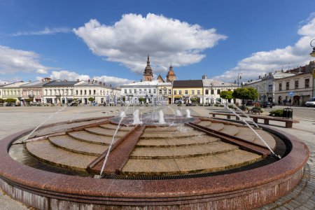 Photo for Nowy Sacz, Poland - August 30, 2022: View of the Market Square with fountain. It is a city in the Lesser Poland Voivodeship in the south of the country. In the background the towers of the Collegiate Basilica of St. Malgorzata - Royalty Free Image
