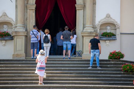 Photo for Kalwaria Zebrzydowska, Poland - August 12, 2018: People on the steps of the church praying during the holy mass, Basilica of Our Lady of the Angels - Royalty Free Image