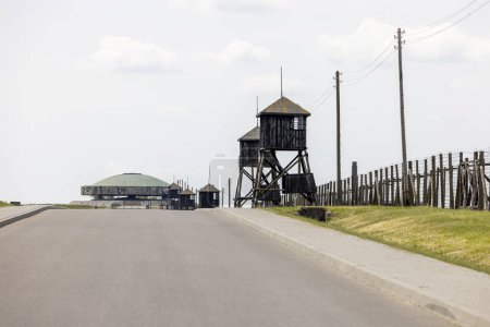 Photo for Majdanek; Lublin; Poland - May 25, 2022: Majdanek concentration and extermination camp ( Konzentrationslager Lublin), view of wooden guard towers, Mausoleum and barbed wire fence. - Royalty Free Image