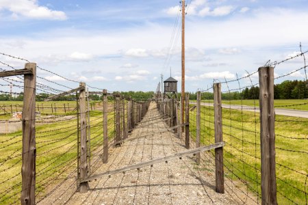 Photo for Majdanek; Lublin; Poland - May 25, 2022: Majdanek concentration and extermination camp, view on barbed wire fence and guard tower. It was a Nazi camp built and operated by the SS during the German occupation of Poland in World War II - Royalty Free Image