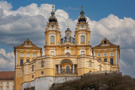 Photo for Melk, Austria - February 24, 2023: View of Melk Abbey with Collegiate Church towers on background of blue sky. It was was founded in 11th century, today's baroque abbey was built in 18th century - Royalty Free Image