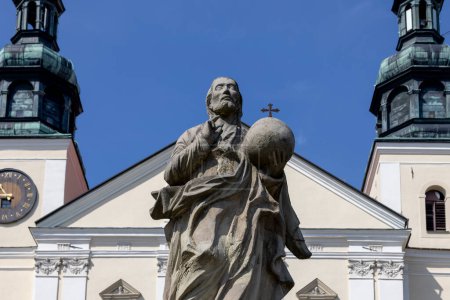 Photo for Kalwaria Zebrzydowska, Poland - August 18, 2022: Sculpture of saint on Paradise Square in front of 17th century Basilica of Our Lady of the Angels - Royalty Free Image