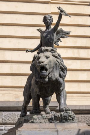 Photo for Naples, Italy - June 27, 2021: Lion and winged genius statues in front of Palazzo della Borsa. It is an allegory of light of the mind taming the wild force - Royalty Free Image