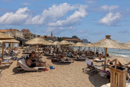 Téléchargez les photos : Budva, Monténégro - 28 juin 2023 : Personnes sur la plage de Ricardova Glava par la mer Adriatique située aux murs de la ville - en image libre de droit