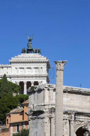 Photo for Rome, Italy - October 8, 2020: Ancient Romun Forum with Column of Phocas and Arch of Septimius Severus. Victor Emmanuel II Monument in a distance - Royalty Free Image