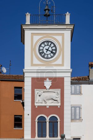Photo for Rovinj, Croatia, Istria - September 29, 2023: Tower with city clock and relief of Venetian lion located on Marshal Tito Square - Royalty Free Image