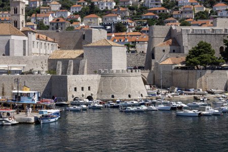 Photo for Dubrovnik, Croatia - June 27, 2023: View of the picturesque medieval Old Port (Stara Luka) by Adriatic Sea with moored ships and Revelin Fort - Royalty Free Image