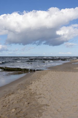 Scenic view of the Baltic Sea, rough water and waves, blue sky with white clouds, Wolin Island, Miedzyzdroje, Poland