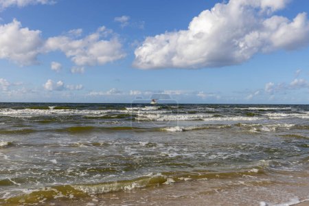 Scenic view of the Baltic Sea, rough water and waves, blue sky with white clouds, Miedzyzdroje, Poland