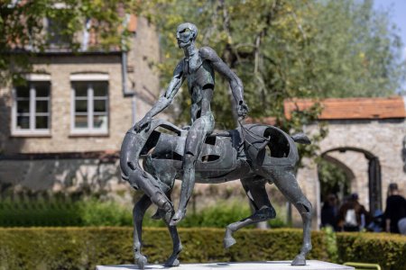 Photo for Bruges, Belgium - May 19, 2023: One of abstract, bronze statues show the Biblical Four Horsemen of the Apocalypse - Royalty Free Image