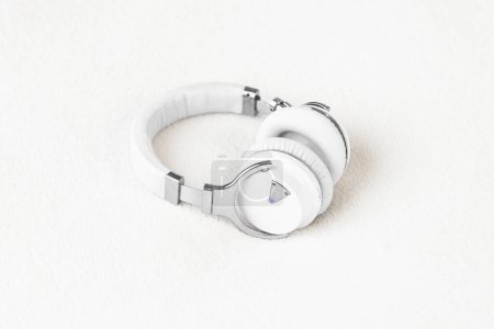 Foto de Headphones big noise cancellation white on soft fluffy clean background - Imagen libre de derechos