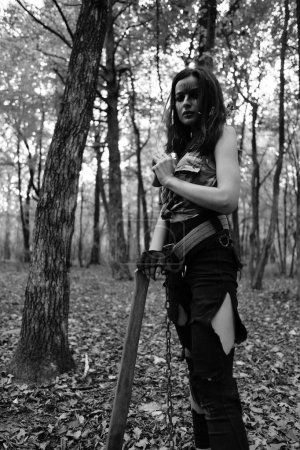 Photo for Black-white photo of a warrior girl in the forest - Royalty Free Image