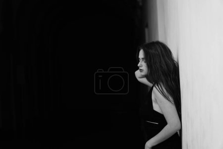 Photo for Black and white photo of a beautiful sensual woman in a black dress posing for the camera - Royalty Free Image