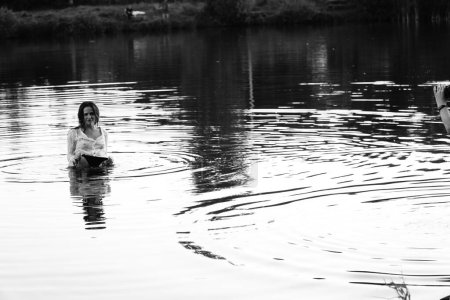 Photo for Black and white photo of a girl on a lake in the park. - Royalty Free Image