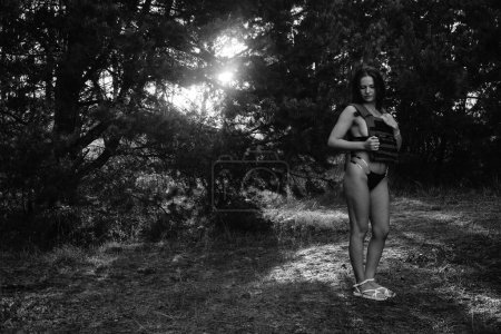 Photo for Black-white photo of a half-naked soldier girl in the forest - Royalty Free Image