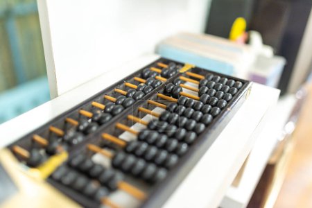 abacus and calculator on the table in the office, business concept