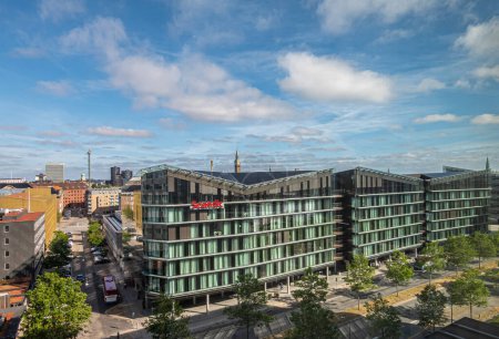 Photo for Copenhagen, Denmark - July 24, 2022: Lerge Scandic Spectrum hotel building on Kalvebod Brygge street under blue cloudscape with cityscape in back. Tivoli and Radhus in back - Royalty Free Image