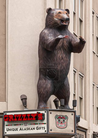 Photo for Anchorage, Alaska, USA - July 23, 2011: Brown aggressive Grizzly bear statue as mascot above entrance to gift shop at corner of West 4th ave and E Street - Royalty Free Image