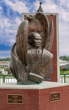 Photo for Anchorage, Alaska, USA - July 23, 2011: President Dwight Eisenhower Statehood monument on corner of Quiyana Park. Brown bronze on red pedestal. Blue cloudscape as backdrop - Royalty Free Image