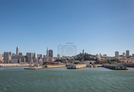 Photo for San Francisco, CA, USA - July 13, 2023: Several docks in front of financial district and downtown cityscape under blue sky with Coit tower in center - Royalty Free Image