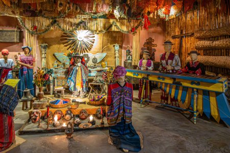 Photo for Guatemala, La Antigua - July 20, 2023: Finca La Azotea museums. Complex scenery setup with large xylophone and several dolls traditionally and colorfully dressed. Some Christian symbols - Royalty Free Image