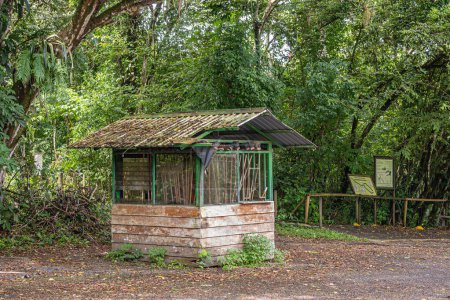 Photo for Costa Rica, Parque Nacional Carara - July 22, 2023: Old and non-maintained Garden tool shed set against green foliage - Royalty Free Image