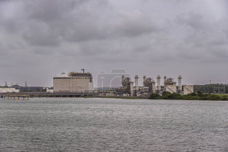 Port of Colon, Panama - July 24, 2023: AES Colon power station or Termoelectrica, heavy industry, buildings and installations to turn coal and gas into heat and electricity under gray cloudscape