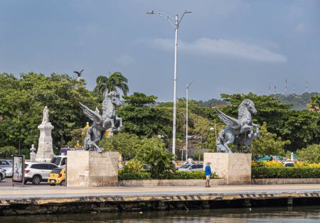 Cartagena, Colombia - July 25, 2023: Double Pegasus statues at end of old town dock with green Centenario Park behind. White marble Nol Me Tanger, Touch Me Not, monument