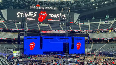 Photo for Las Vegas, NV, USA - May 11, 2024: Large electronic billboards advertising Rollong Stones Hackney Diamonds concert inside Allegiant Stadium. People are starting to come in - Royalty Free Image