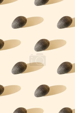 Photo for Avocado on beige pastel background with long shadows. Minimal healthy organic food concept. Flat lay, top view - Royalty Free Image