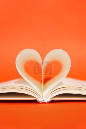 Photo for Open book with pages in heart shape on a bright orange background. Book Lovers Day. Knowledge day. Back to school minimal concept. Space for text. Copy space - Royalty Free Image